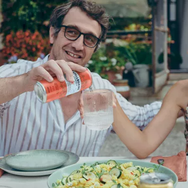 Guy pourung S.Pellegrino Essenza Blood Orange flavour