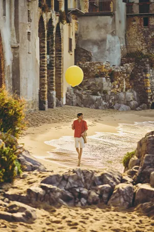 guy playing with a lemon baloon