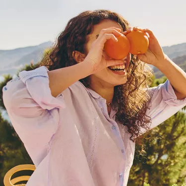 girl laying with oranges