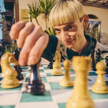 guy playing chess with oranges