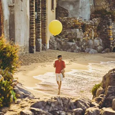 guy playing with a lemon baloon