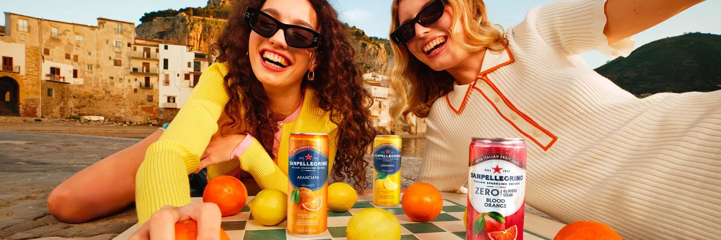 two smiling girls with sanpellegrino italian sparkling drinks