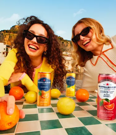 two smiling girls with sanpellegrino italian sparkling drinks mobile